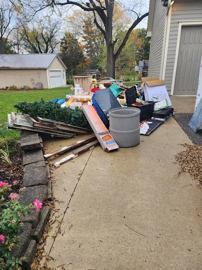 Dumpster being loaded with debris for 30 Yard Dumpster Rental in Tuskegee